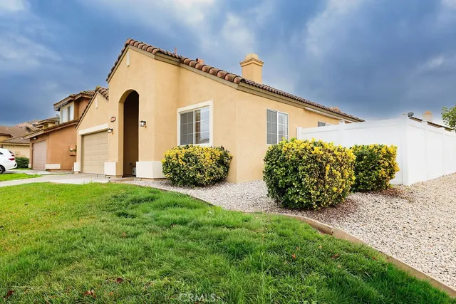 a front view of a house with a garden