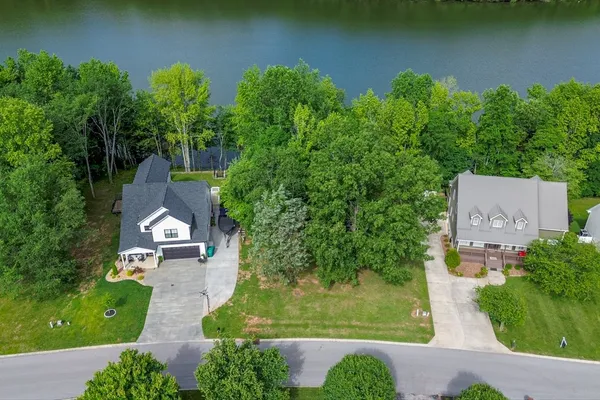 an aerial view of a house with garden space and outdoor seating