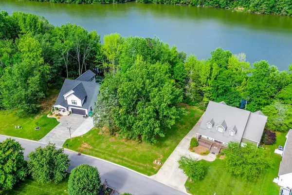 an aerial view of a house with a yard and outdoor seating