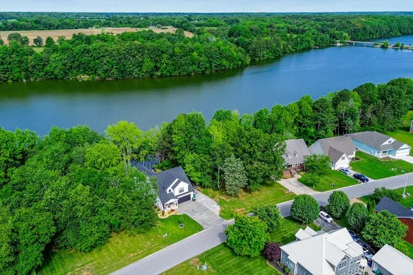 an aerial view of a house with a garden and swimming pool