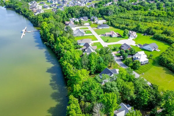an outdoor space with swimming pool and green space