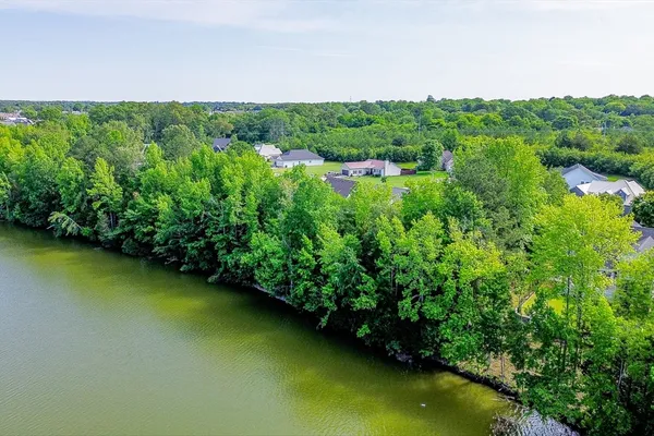 an aerial view of residential houses with outdoor space and swimming pool
