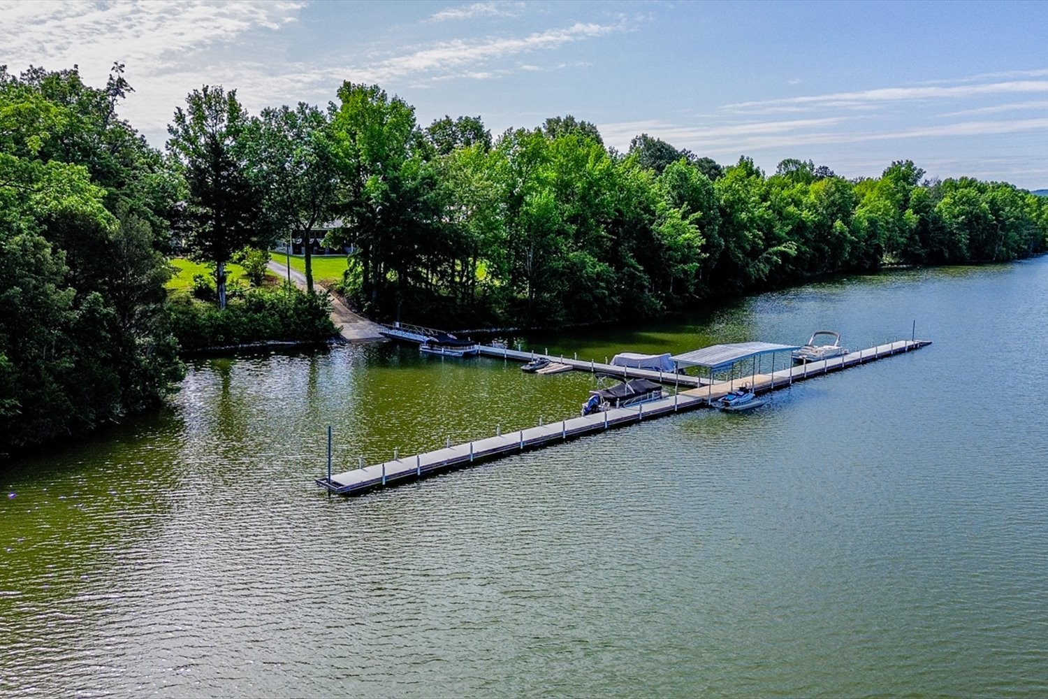 6 Cypress Point Drive Winchester, TN 37398 - Photo 50 of 58 a view of a lake with lawn chairs and a large tree