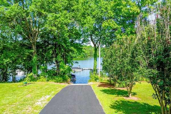 a front view of a house with a yard and trees