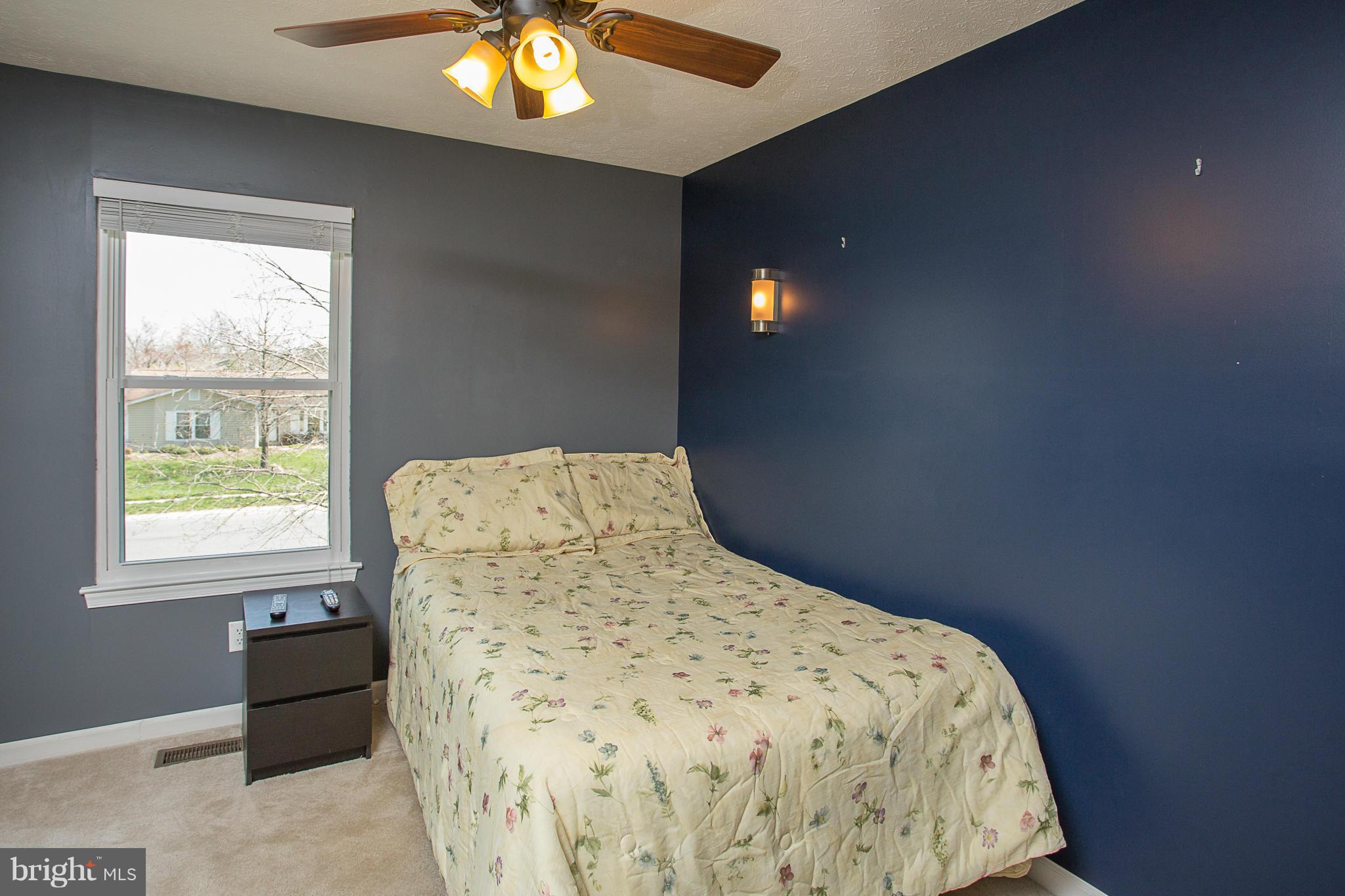 8208 Grassland Road Severn, MD 21144 - Photo 23 of 30 a bed sitting in a bedroom next to a window