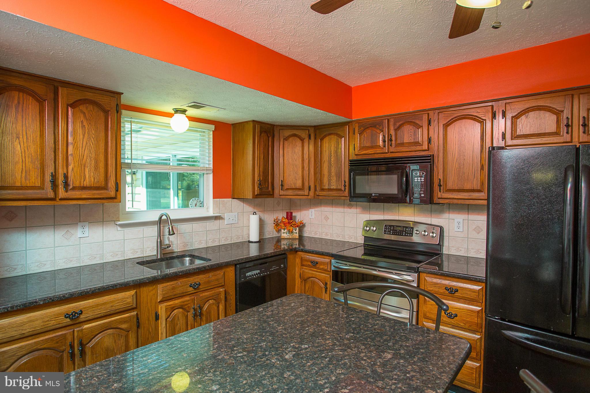 8208 Grassland Road Severn, MD 21144 - Photo 7 of 30 a kitchen with stainless steel appliances granite countertop a refrigerator and a sink