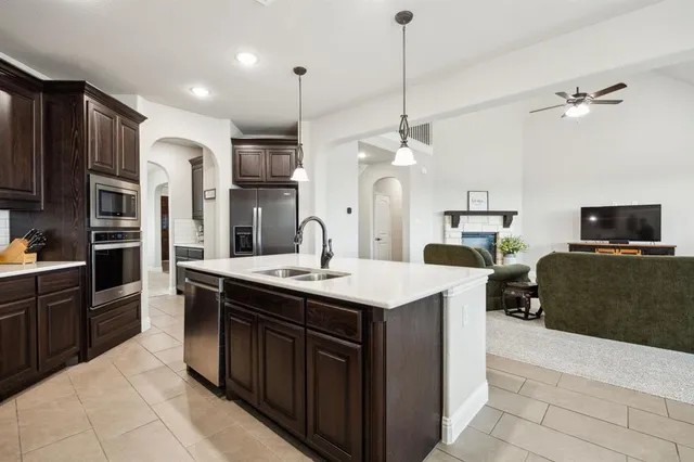 a kitchen with stainless steel appliances a sink stove and refrigerator
