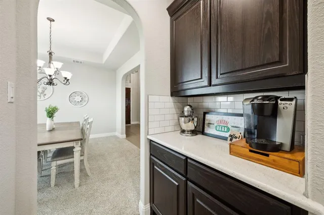 a kitchen with sink and refrigerator