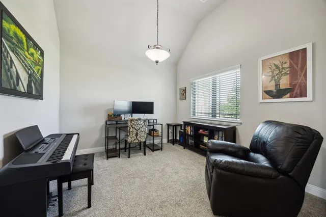 a livingroom with workspace couch and a window