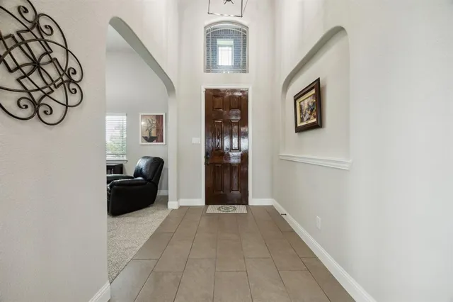 a view of a hallway with wooden floor and entryway