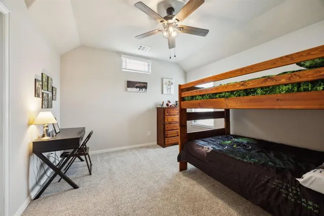 a bedroom with furniture and a chandelier fan