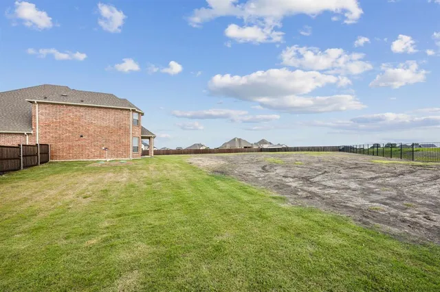 a view of a big yard with table and chair