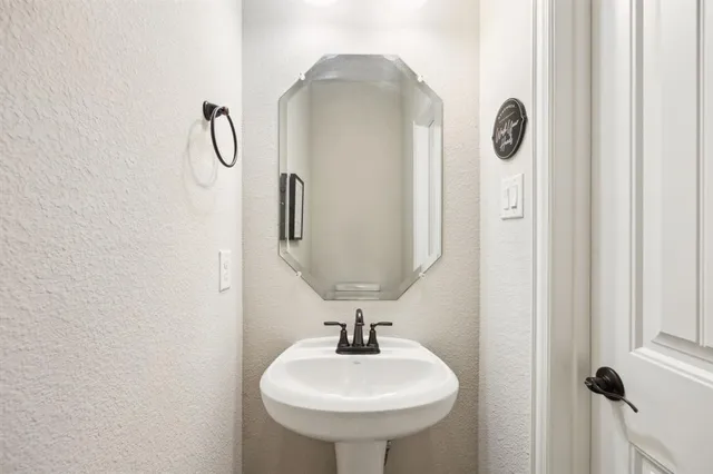 a bathroom with a sink and mirror
