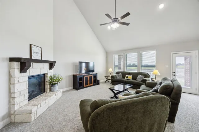 a living room with furniture a fireplace and a flat screen tv