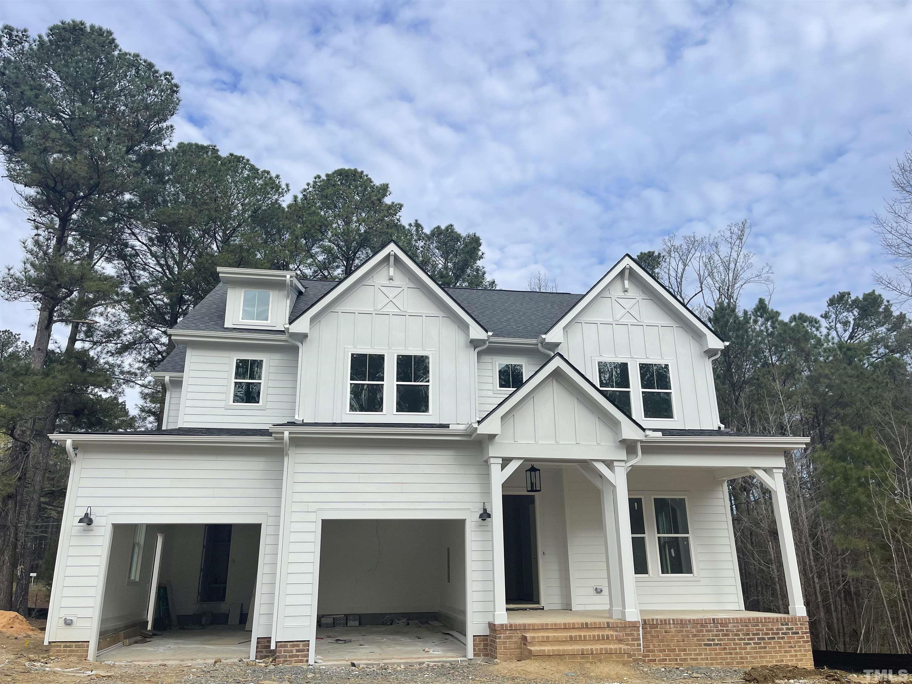 105 Sanderway Drive Chapel Hill, NC 27516 - Photo 1 of 24 a view of a white house with large windows