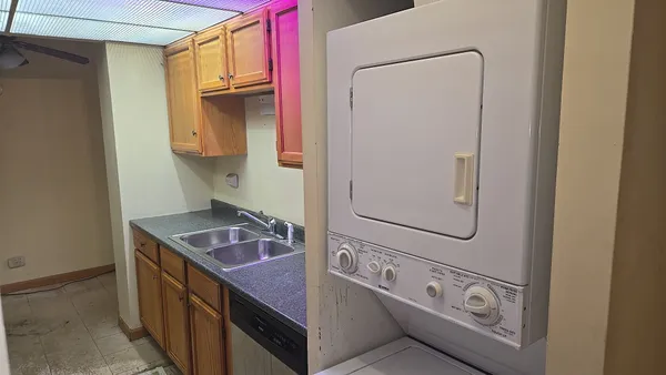 a bathroom with a granite countertop sink a vanity and shower