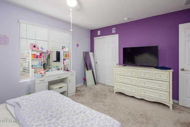 a bed room with a bed and a flat screen tv