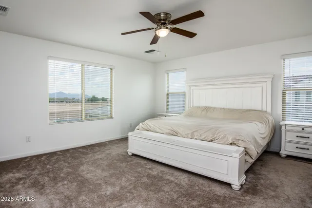 a spacious bedroom with a bed and window