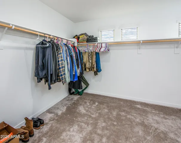 a view of walk in closet with clothes