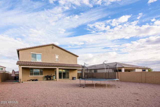 a view of a house with a backyard