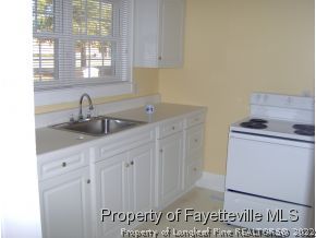 125 Reservation Road Aberdeen, NC 28315 - Photo 5 of 7 a kitchen with sink and cabinets