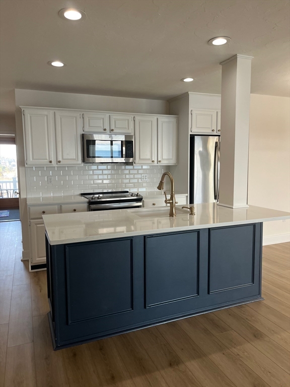 66 Glades Road, Unit 5 Scituate, MA 02066 - Photo 3 of 14 a kitchen with stainless steel appliances a sink stove and refrigerator