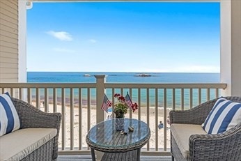 66 Glades Road, Unit 5 Scituate, MA 02066 - Photo 4 of 11 a balcony with furniture and a potted plant