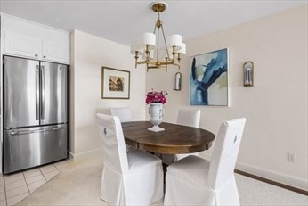 66 Glades Road, Unit 5 Scituate, MA 02066 - Photo 5 of 11 a view of a dining room with furniture and a chandelier
