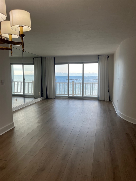 66 Glades Road, Unit 5 Scituate, MA 02066 - Photo 5 of 14 an empty room with wooden floor and windows