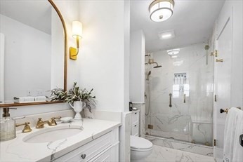 66 Glades Road, Unit 5 Scituate, MA 02066 - Photo 7 of 11 a bathroom with a granite countertop sink a toilet and shower