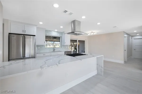 a kitchen with stainless steel appliances a refrigerator and a sink