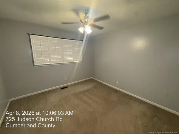 an view of an empty room with a window