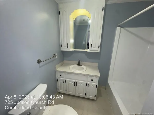 a bathroom with a granite countertop sink a mirror and a vanity