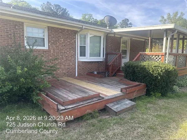 a wooden bench sitting in front of a house