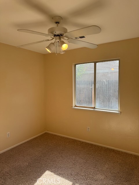 8707 Winlock Street Bakersfield, CA 93312 - Photo 10 of 18 a view of an empty room with a window
