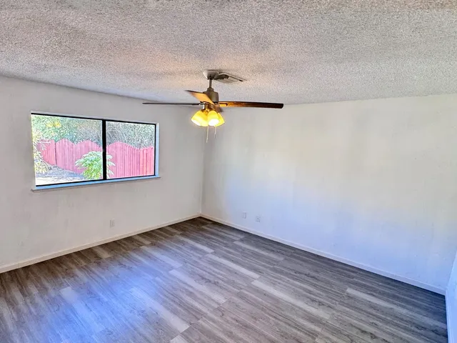 a view of a room with wooden floor