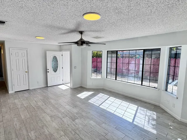 a view of a room with furniture and window