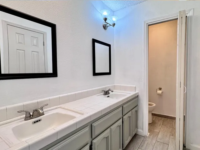 a bathroom with a double vanity sink and a mirror