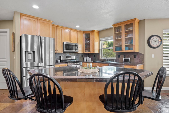 288 South Hillside Drive Elk Ridge, UT 84651 - Photo 8 of 27 beautiful kitchen cabinetry stainless steel appliances, a breakfast bar, and a kitchen island