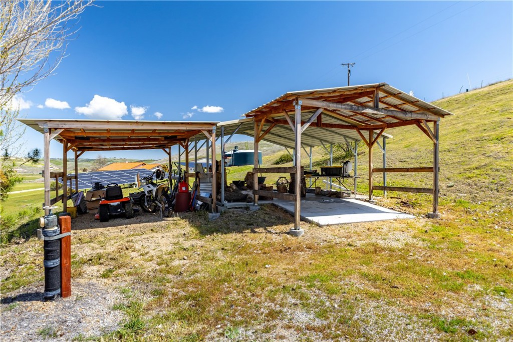 76870 Barker Road San Miguel, CA 93451 - Photo 57 of 66 a view of a garage with a table and chairs under an umbrella