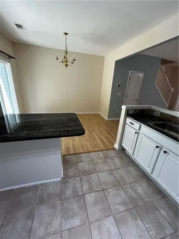 a kitchen with a stove cabinets and window