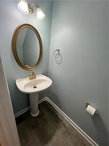 a bathroom with a sink toilet and mirror