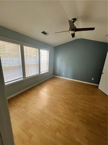 an empty room with a empty space and windows