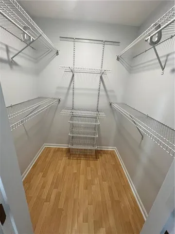 a view of walk in closet with empty racks