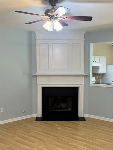 a living room with a fireplace and wooden floor
