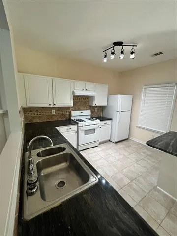 a kitchen with furniture and a stove