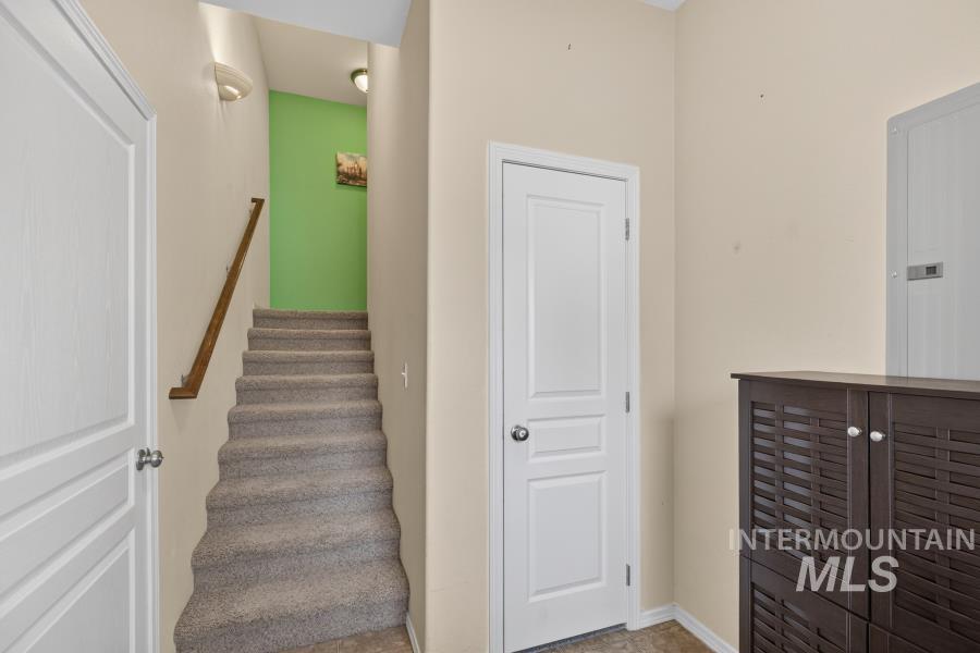 1337 Bristol Road Moscow, ID 83843 - Photo 2 of 28 Carpeted staircase with a wood handrail and light green accent wall