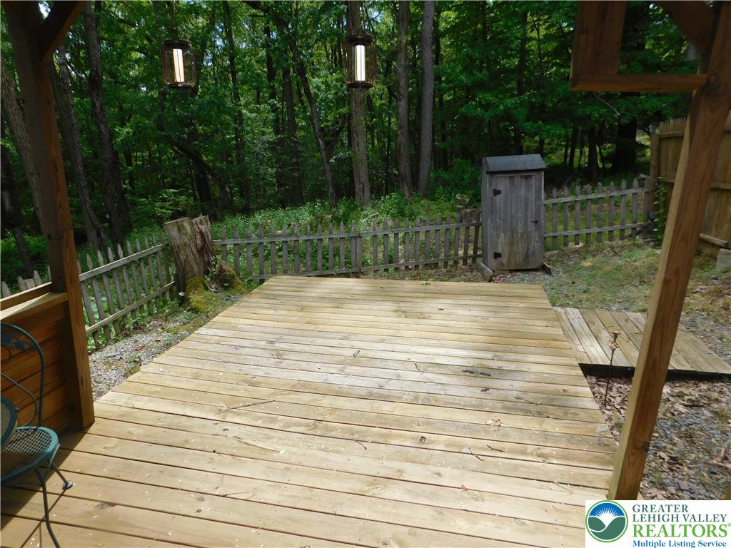 41 Reeder Street Mount Pocono, PA 18344 - Photo 11 of 41 A spacious wooden deck provides a private outdoor retreat surrounded by a verdant forest.