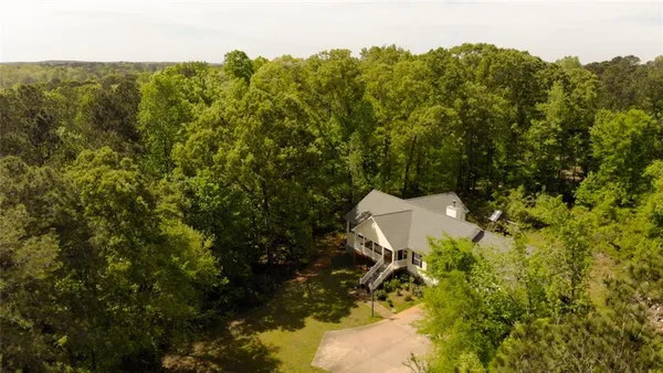 an aerial view of a house with a yard