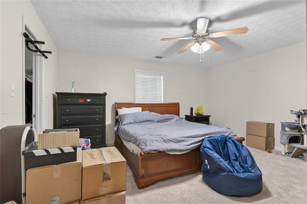120 Norman Road Covington, GA 30014 - Photo 18 of 31 a bedroom with a bed and ceiling fan